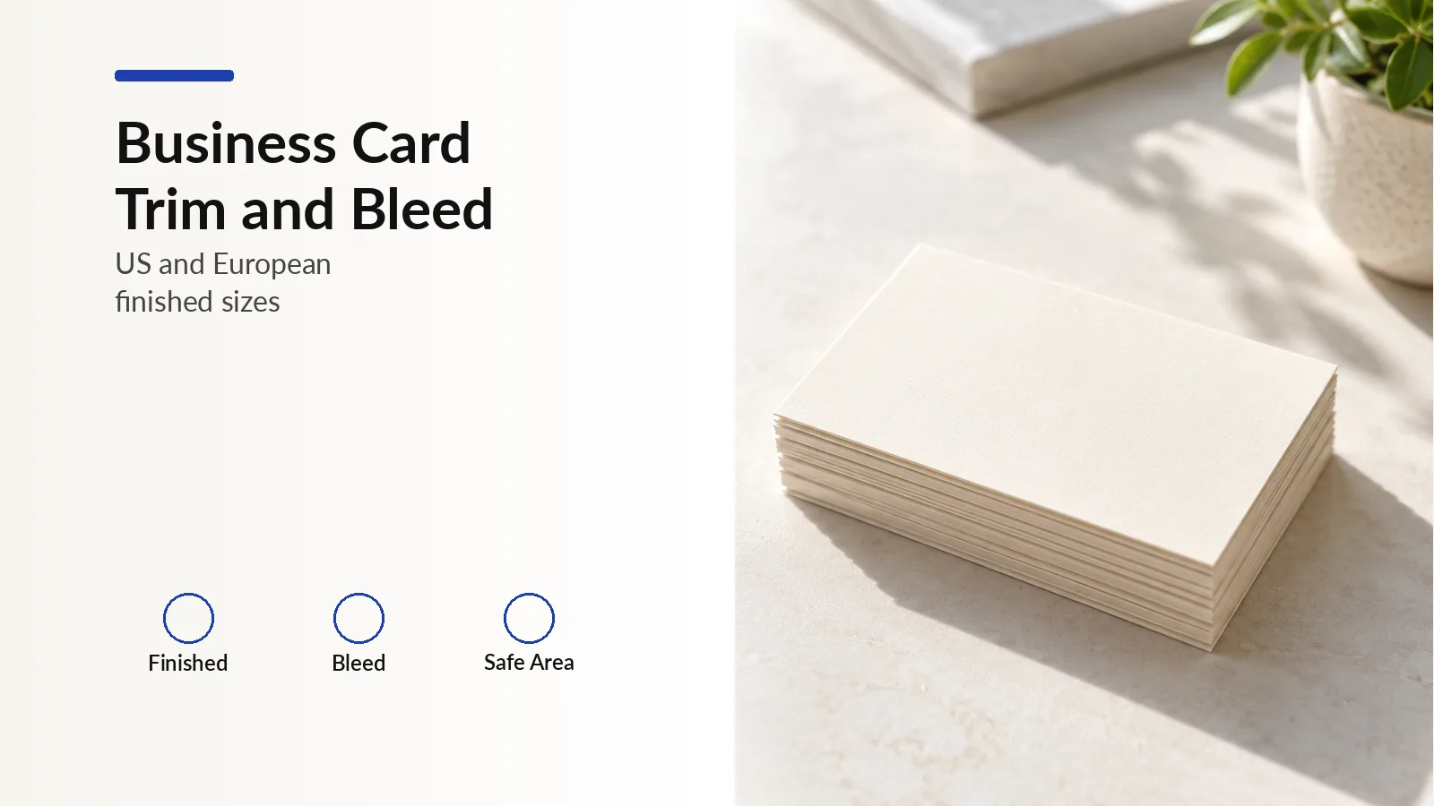 Stack of blank cream business cards on a pale stone desk.